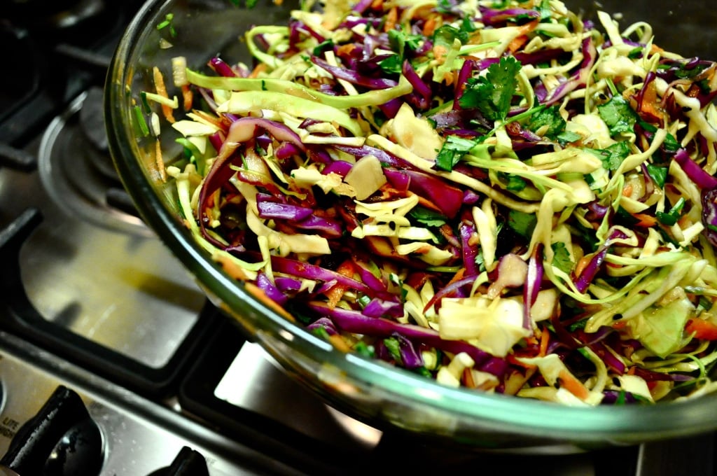 glass bowl of asian coleslaw on a stove