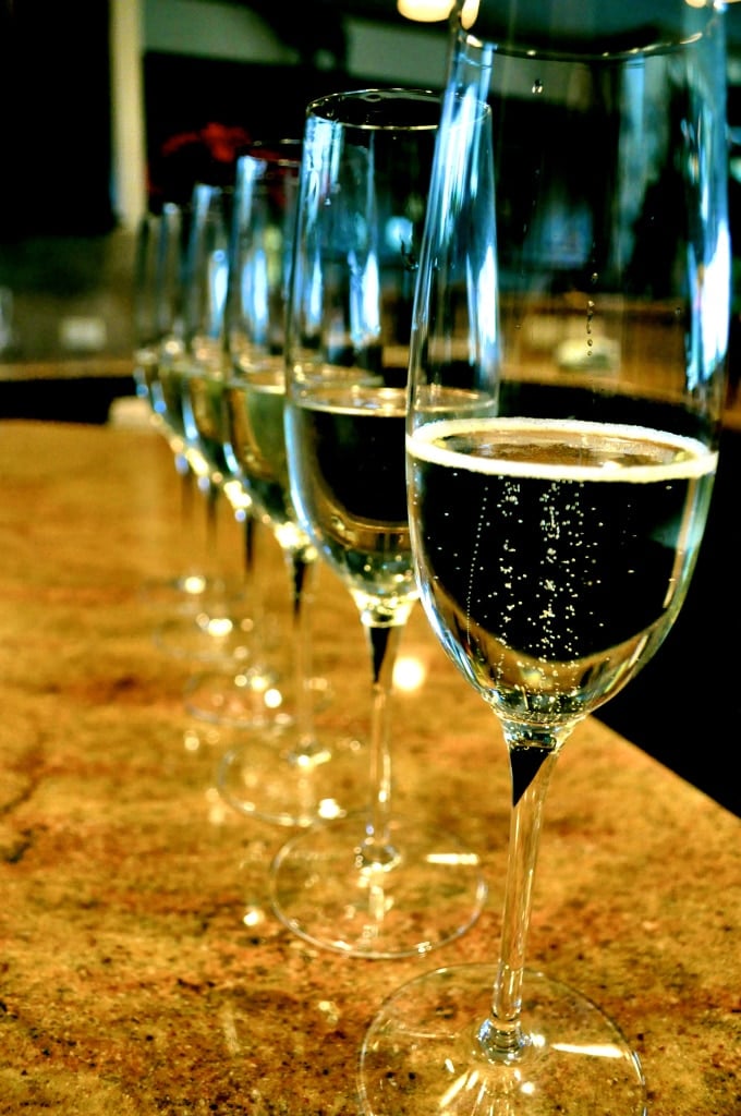 a line of full champagne glasses ready for the new year