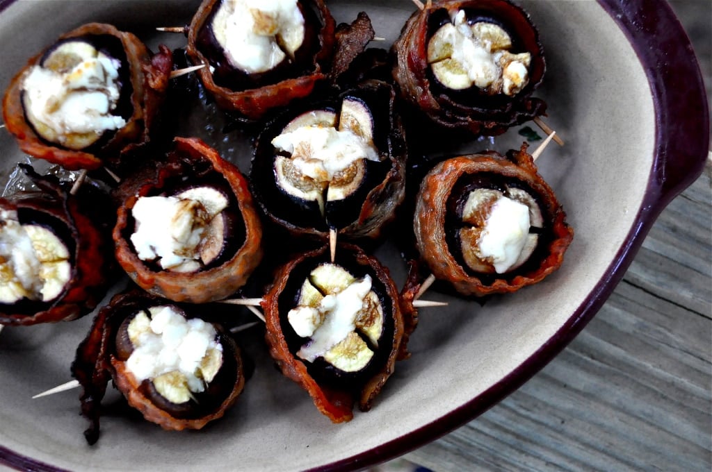 overhead view of a bowl of figs stuffed with goat cheese and wrapped in bacon