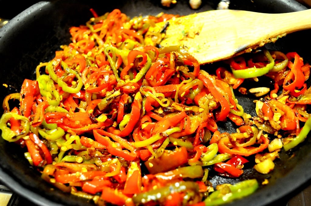 onions and peppers in a pan