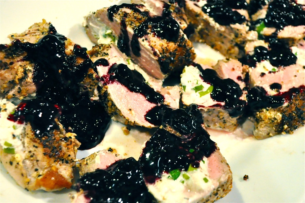 blueberry reduction drizzled on top of sliced pork chops