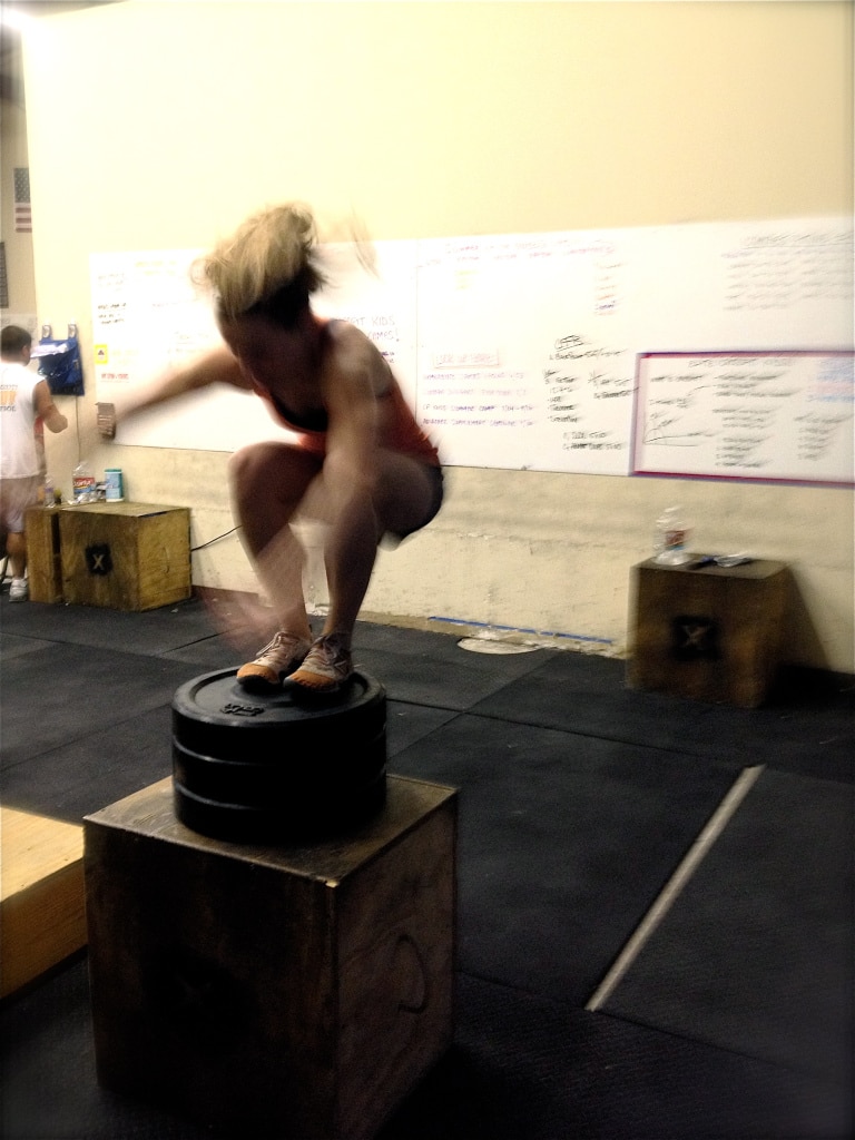 woman jumping on box