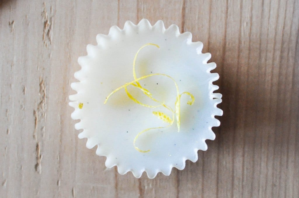 one white lemon vanilla beltway topped with yellow lemon zest on a wooden board