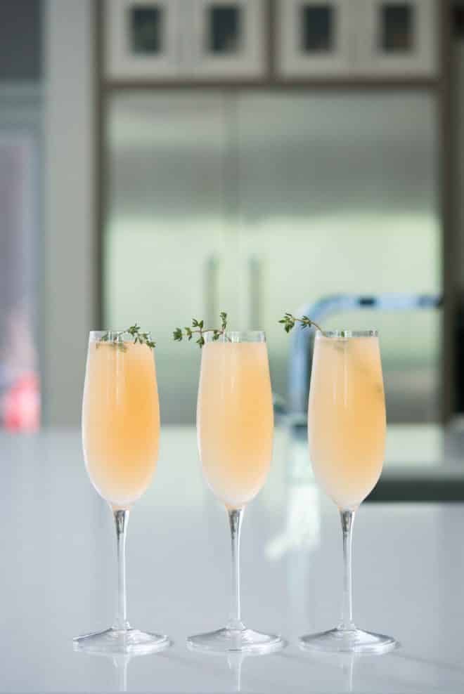 elderflower grapefruit mimosa in three champagne flutes