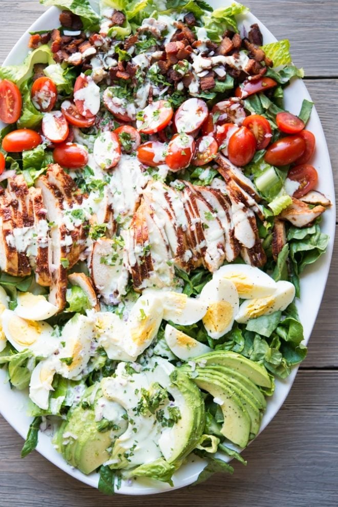 overhead view of a plate of BBQ chicken Cobb salad with jalapeno ranch 