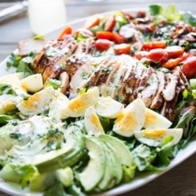 a plate of BBQ chicken Cobb salad with jalapeno ranch
