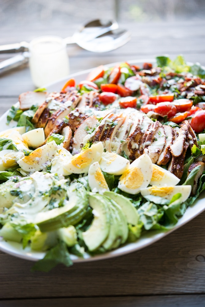 a plate of BBQ chicken Cobb salad with jalapeno ranch