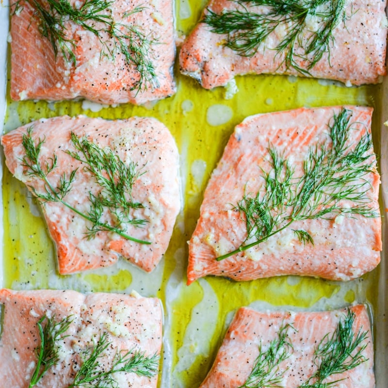 dill and garlic baked salmon on parchment paper