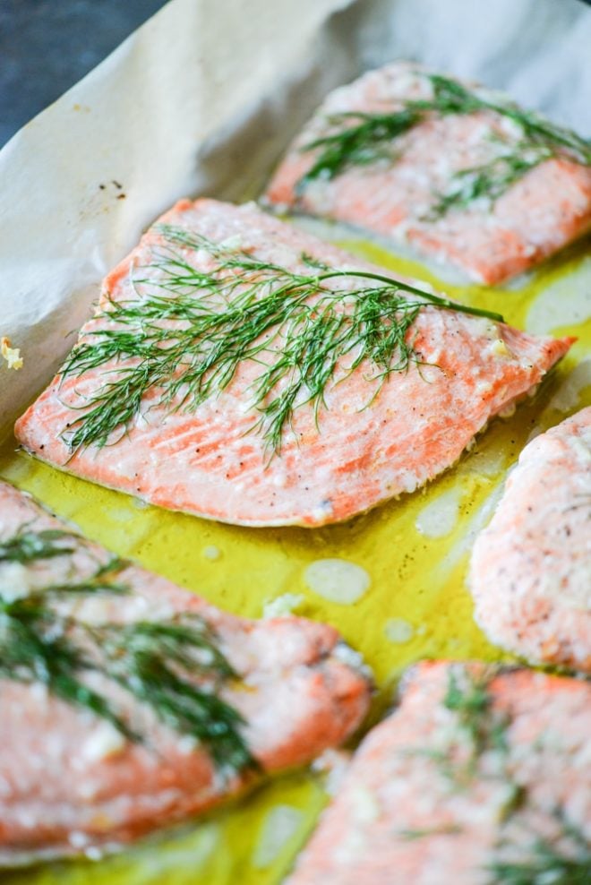 dill and garlic baked salmon on parchment paper