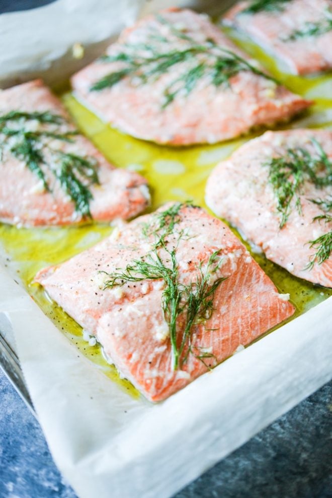 dill and garlic baked salmon on parchment paper