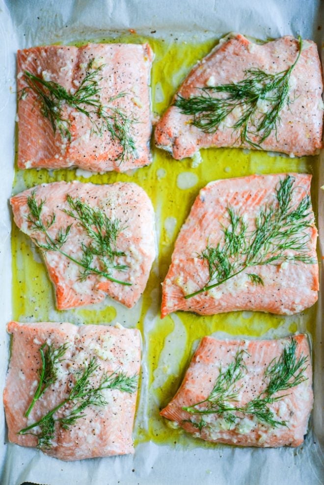 dill and garlic baked salmon on parchment paper