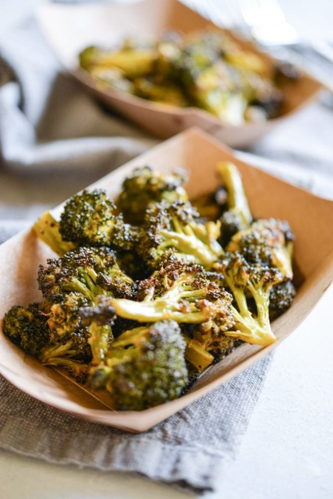 buffalo broccoli in a brown paper food boat on top of a grey napkin