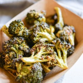 buffalo broccoli in a brown paper food boat on top of a grey napkin