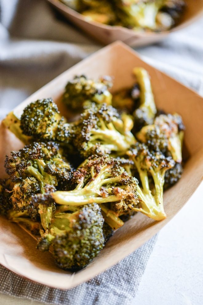 buffalo broccoli in a brown paper food boat on top of a grey napkin