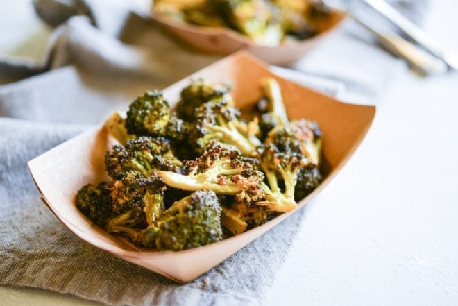 buffalo broccoli in a brown paper food boat on top of a grey napkin