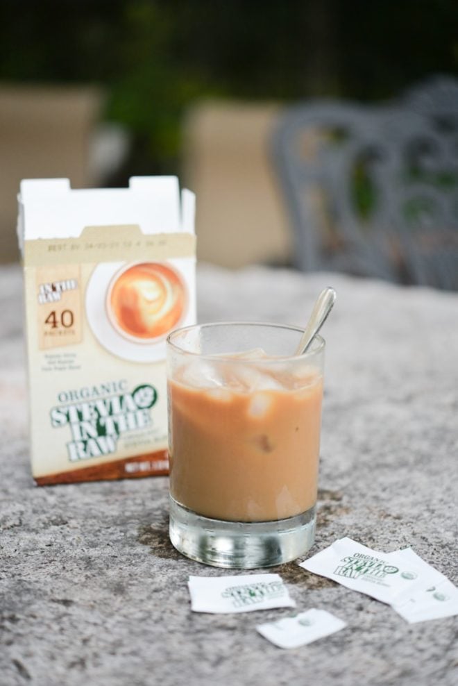 glass cup filled with caramel colored coffee with two packets of stevia in the raw on the table