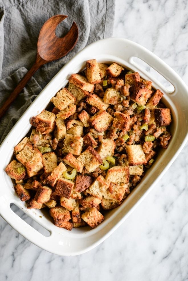 This old-fashioned gluten free stuffing combines traditional flavors of crumbled sausage, fresh herbs, onions, garlic, and celery to create the perfect side dish that will steal the show on your Thanksgiving table! | Fed & Fit