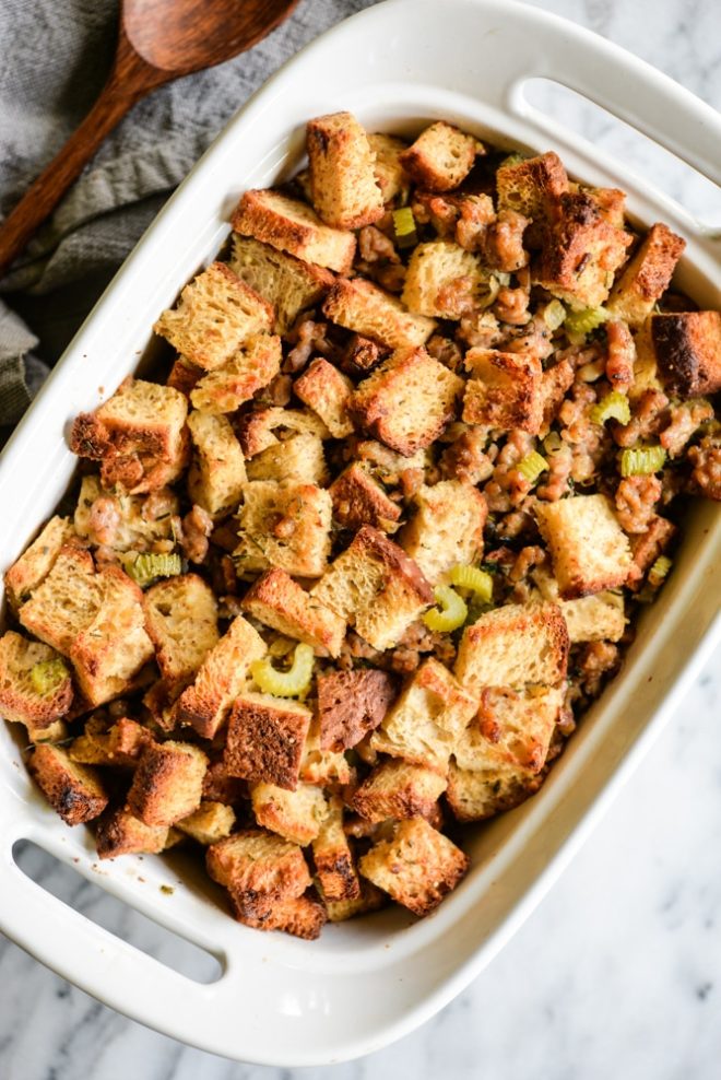 This old-fashioned gluten free stuffing combines traditional flavors of crumbled sausage, fresh herbs, onions, garlic, and celery to create the perfect side dish that will steal the show on your Thanksgiving table! | Fed & Fit