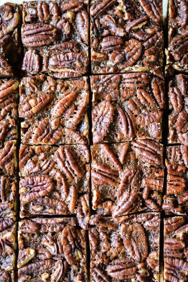 These pecan pie bars are gluten and refined sugar-free and combine traditional pecan pie filling with a buttery shortbread crust. They are perfect to impress your guests this Thanksgiving! | Fed & Fit