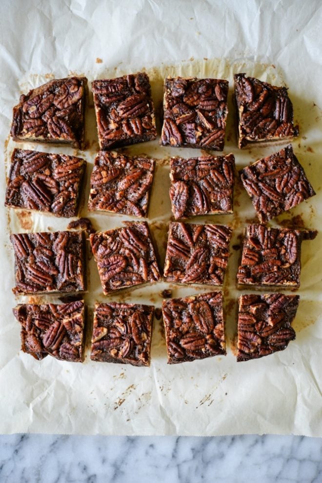These pecan pie bars are gluten and refined sugar-free and combine traditional pecan pie filling with a buttery shortbread crust. They are perfect to impress your guests this Thanksgiving! | Fed & Fit