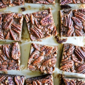 These pecan pie bars are gluten and refined sugar-free and combine traditional pecan pie filling with a buttery shortbread crust. They are perfect to impress your guests this Thanksgiving! | Fed & Fit