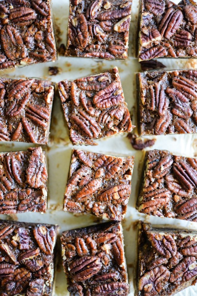 These pecan pie bars are gluten and refined sugar-free and combine traditional pecan pie filling with a buttery shortbread crust. They are perfect to impress your guests this Thanksgiving! | Fed & Fit