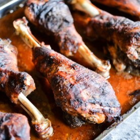 These BBQ turkey legs are roasted in the oven to juicy perfection and come together quickly with just a few ingredients for the perfect change-up to your normal Thanksgiving protein! | Fed & Fit