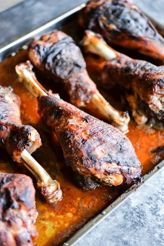 These BBQ turkey legs are roasted in the oven to juicy perfection and come together quickly with just a few ingredients for the perfect change-up to your normal Thanksgiving protein! | Fed & Fit