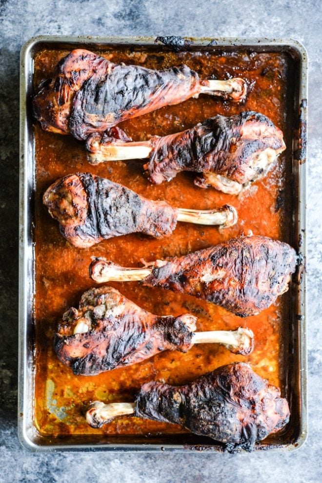 These BBQ turkey legs are roasted in the oven to juicy perfection and come together quickly with just a few ingredients for the perfect change-up to your normal Thanksgiving protein! | Fed & Fit