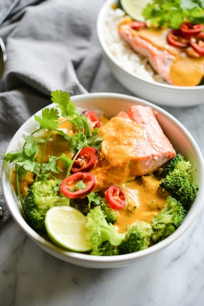 These easy bowl feature quick pan-seared salmon, an Indian coconut curry sauce, steamed broccoli, and rice for an easy one bowl dinner! | Fed & Fit