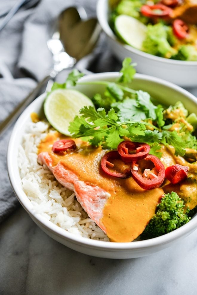 These easy bowl feature quick pan-seared salmon, an Indian coconut curry sauce, steamed broccoli, and rice for an easy one bowl dinner! | Fed & Fit