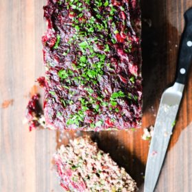 This Paleo bison cranberry meatloaf is the perfect healthy winter comfort food. It is incredibly flavorful, packs a big superfood punch, and the tangy cranberry sauce topping makes it perfectly festive for the holiday season!