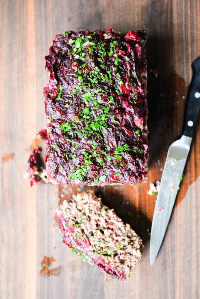 This Paleo bison cranberry meatloaf is the perfect healthy winter comfort food. It is incredibly flavorful, packs a big superfood punch, and the tangy cranberry sauce topping makes it perfectly festive for the holiday season!