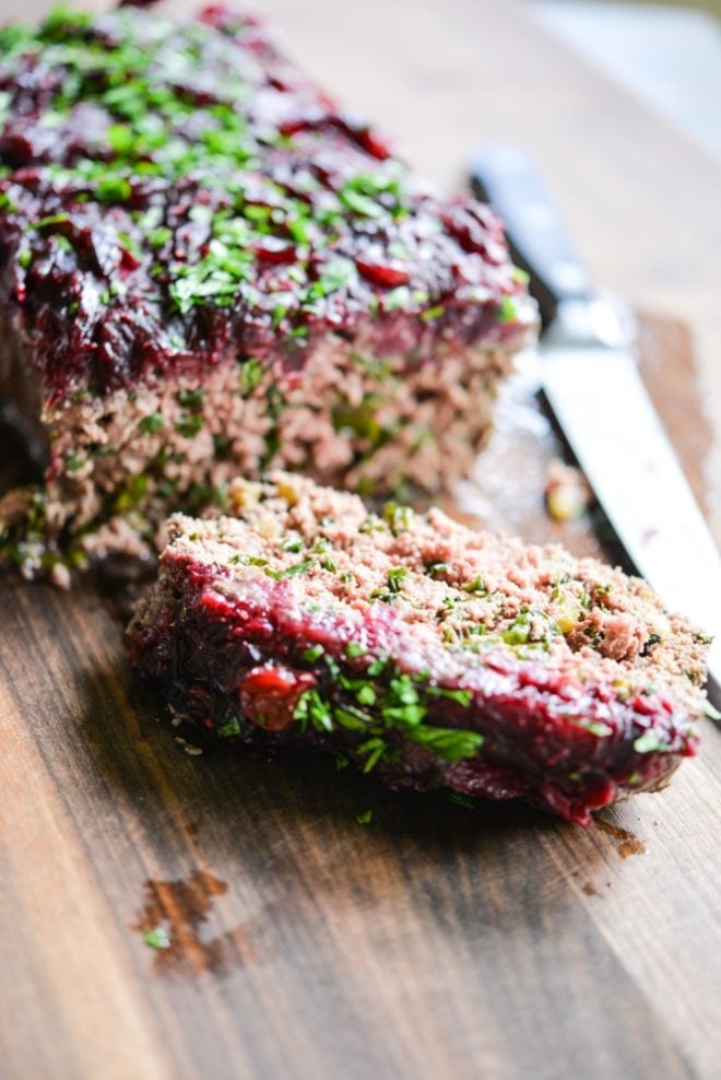 This Paleo bison cranberry meatloaf is the perfect healthy winter comfort food. It is incredibly flavorful, packs a big superfood punch, and the tangy cranberry sauce topping makes it perfectly festive for the holiday season!