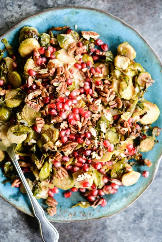 Brussels sprouts slaw features crispy shredded Brussels sprouts, tangy red wine vinaigrette, bright pomegranate seeds, and chopped pecans. It is the perfect winter side dish!
