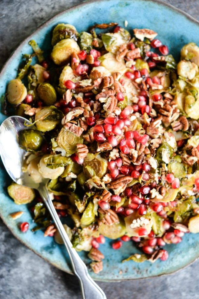 This Pomegranate Brussels Sprouts Slaw is tangy with a hint of sweet, crunch from the pecans, and the perfect side dish for your holiday table!
