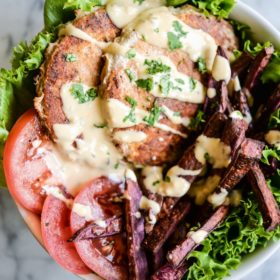 overhead view of chipotle chicken burger bowls with purple sweet potato fries