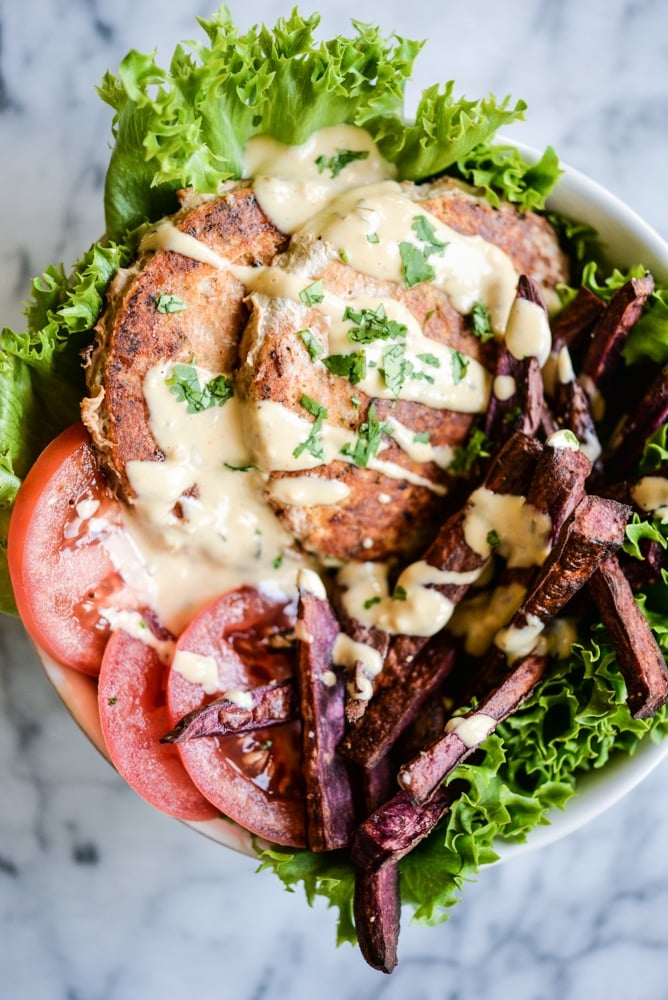 overhead view of chipotle chicken burger bowls with purple sweet potato fries