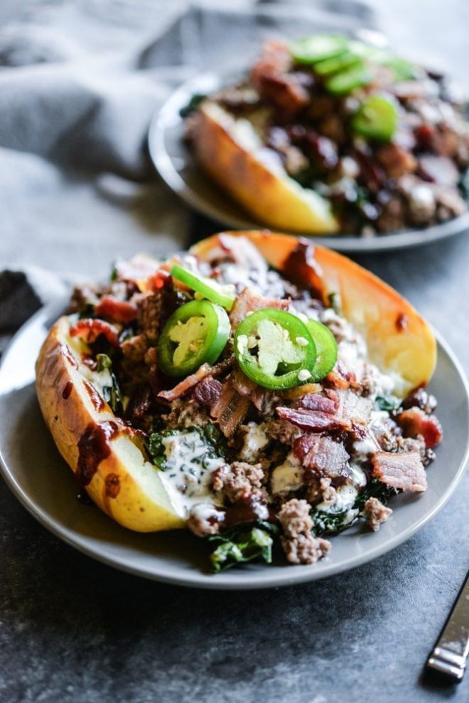 meal prep bbq bacon burger loaded potatoes on a plate topped with jalapenos