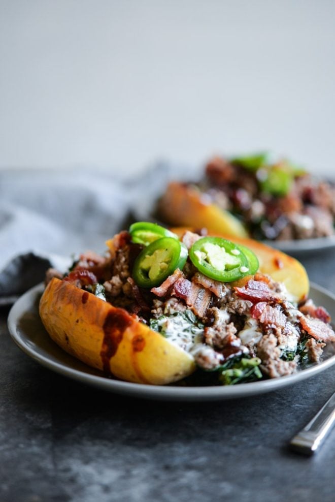 meal prep bbq bacon burger loaded potatoes on a plate topped with jalapenos