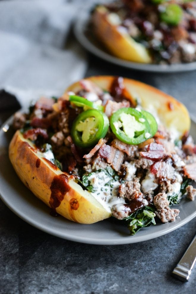 meal prep bbq bacon burger loaded potatoes on a plate topped with jalapenos