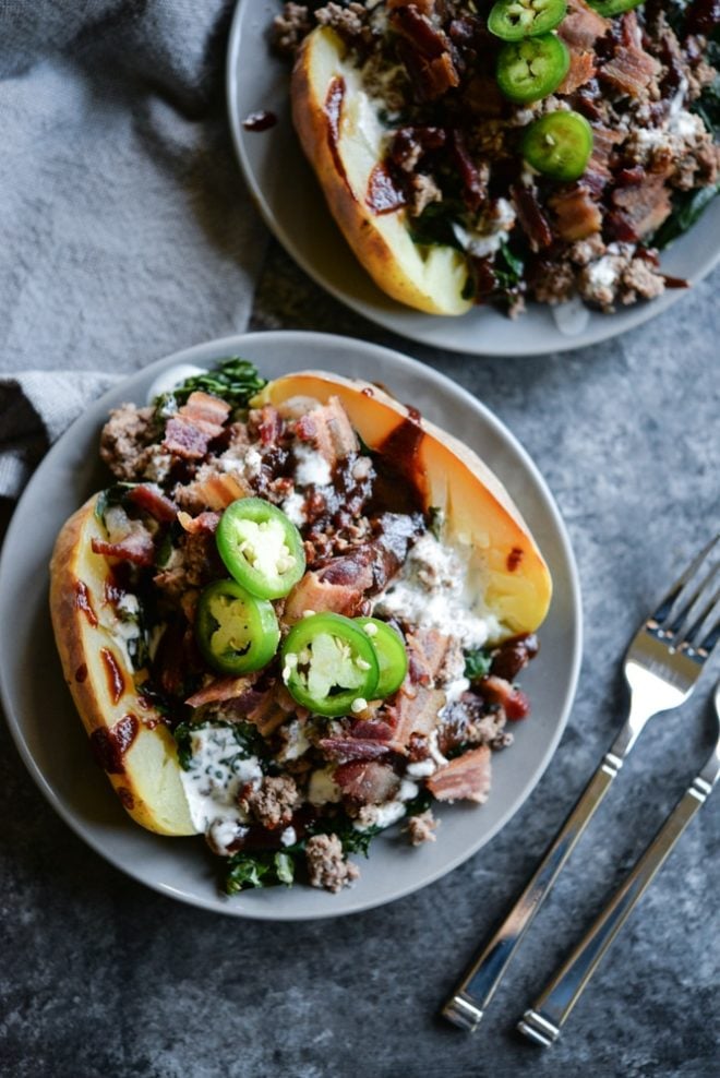 overhead view of meal prep bbq bacon burger loaded potatoes on a plate topped with jalapenos