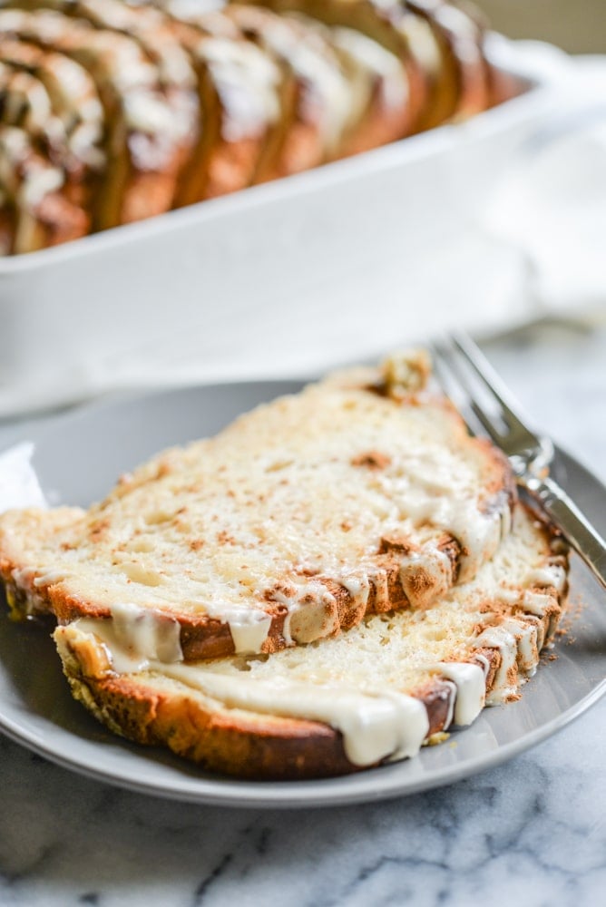 two slices of cinnamon french toast bake on a grey plate