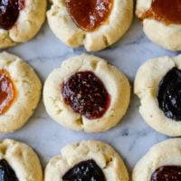 These easy gluten free jam thumbprint cookies have a buttery shortbread base that is topped with your choice of jam (we love raspberry and apricot!) or you could melt chocolate in side for a Christmas treat that will please everyone!