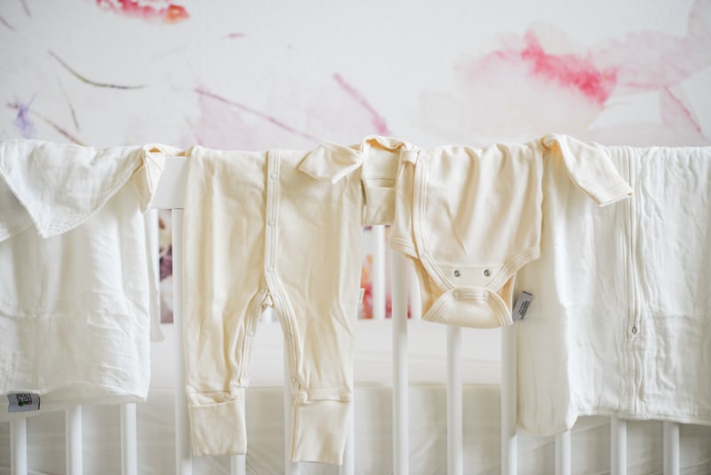 how I'm choosing safer baby products clothing draped over the crib