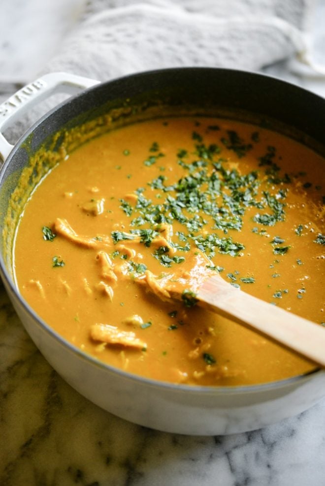 meal prep Curried Butternut Squash Soup in a white cast iron pot