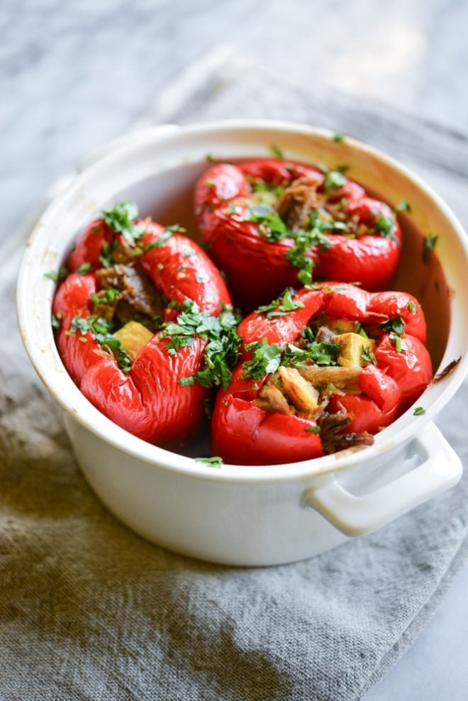 meal prep carnitas stuffed red bell peppers in a white casserole dish