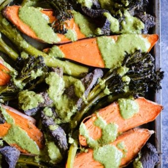 overhead view of chimichurri beef sheet pan dinner with beef, sweet potatoes, and broccolini