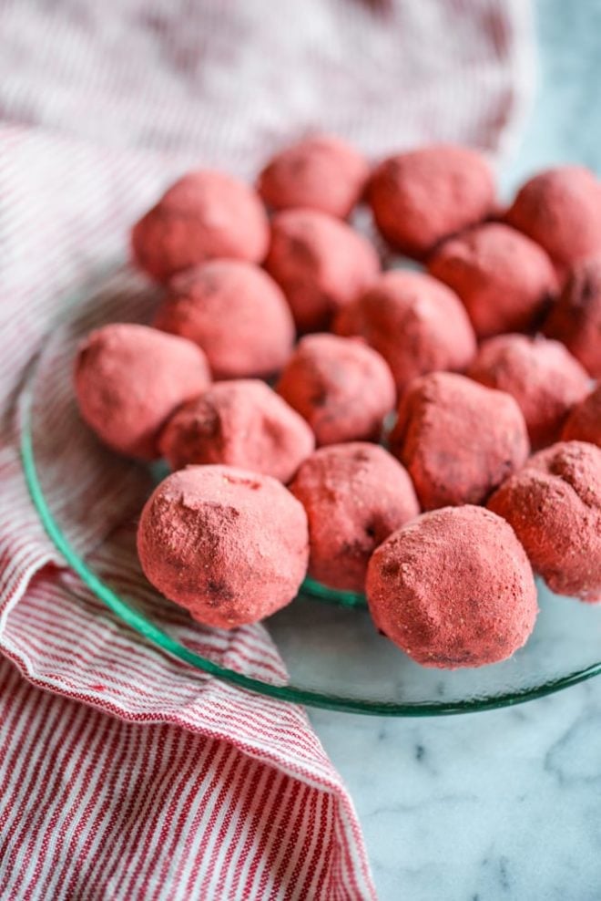 a green glass plate of Dark Chocolate Strawberry Truffles