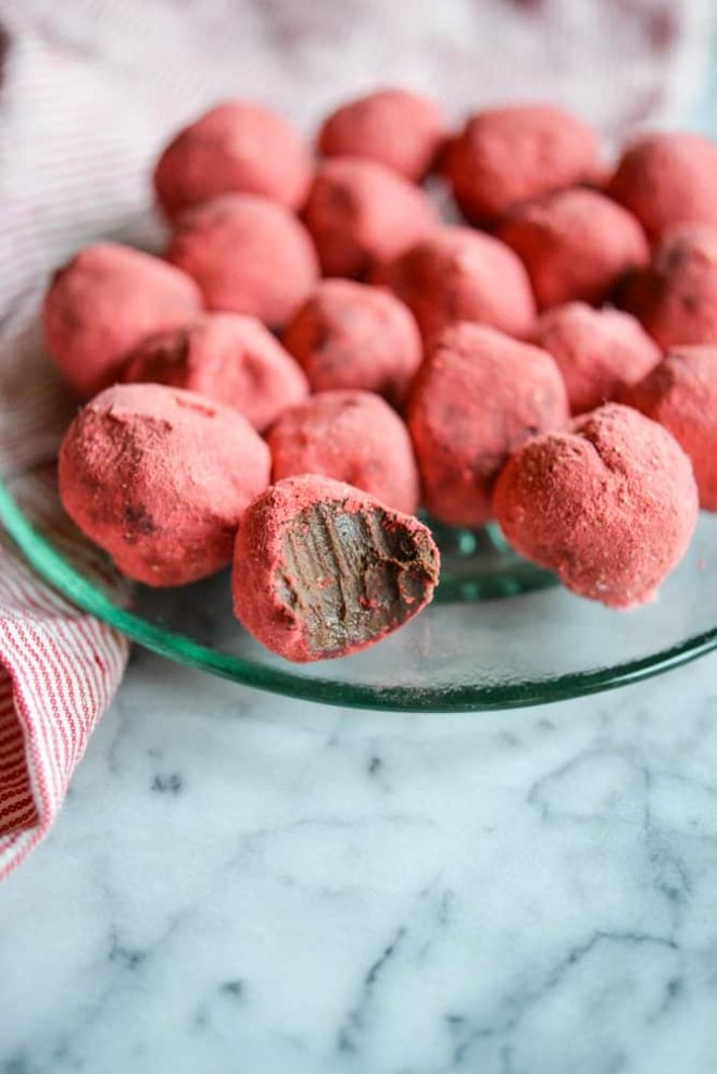 a green glass plate of Dark Chocolate Strawberry Truffles